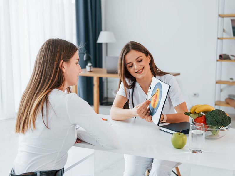 woman-showing-illustration-to-the-female-customer-resize.jpg